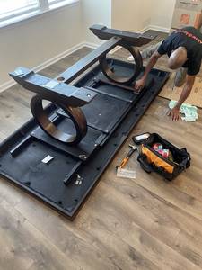 Movers disassembling a table