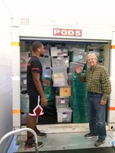 Movers and customer standing on the back of a POD ready to be moved